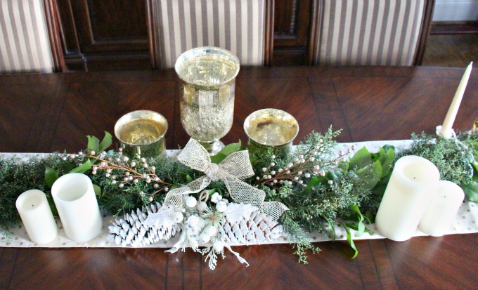 Candles and gold accents were used to finish the dining room table.