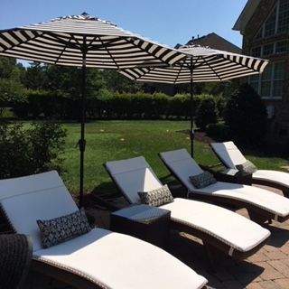 Black and white Market umbrellas and Frontgate Balengia chaise lounges. www.jennelyinteriors.com