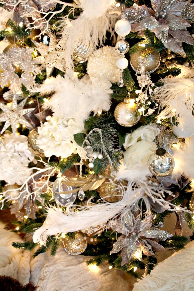 The white feathers make the tree a perfect winter wonderland. www.jennelyinteriors.com