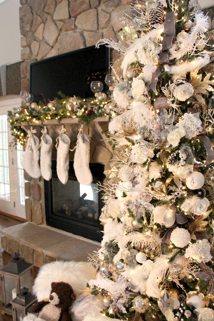The fireplace looks so amazing next to this tree. www.jennelyinteriors.com