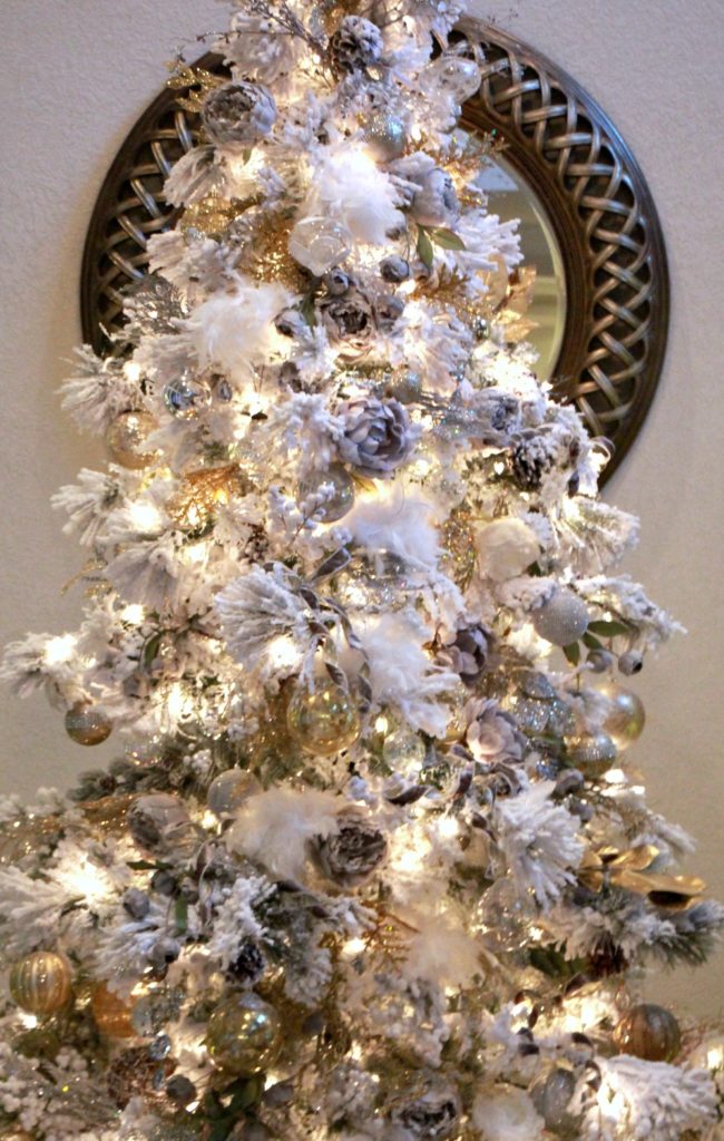 I love the neutral palette I used on my 9' flocked tree this year. This gold and silver classic look is always in style.