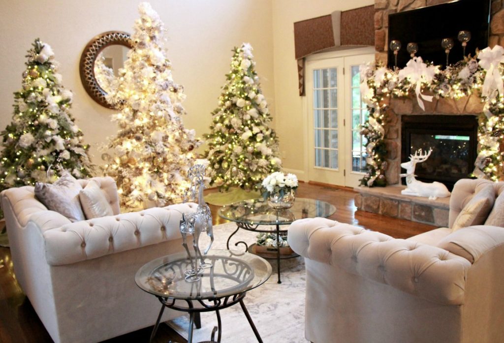 3 Christmas trees done in silver, gold and white for a glam, Christmas look. 9' flocked tree- Jenn Ely Interiors