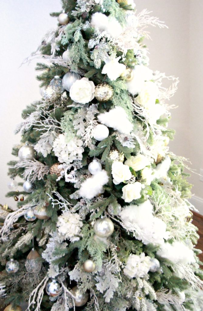 The green trees decked out in mainly white decor as just as beautiful as the flocked trees. 